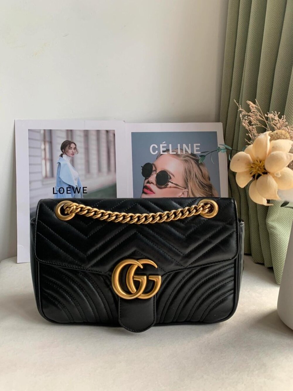 Gucci GG Marmont quilted leather black shoulder bag with gold chain.